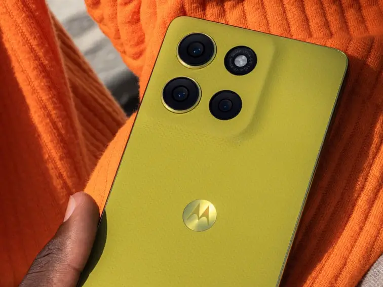 Moto G86 Power Indian variant in olive green with triple rear cameras, placed against an orange fabric background, with white text identifying the model